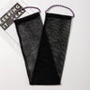 A pair of black exfoliating body scrub sponges with purple string handles are shown on a white background.