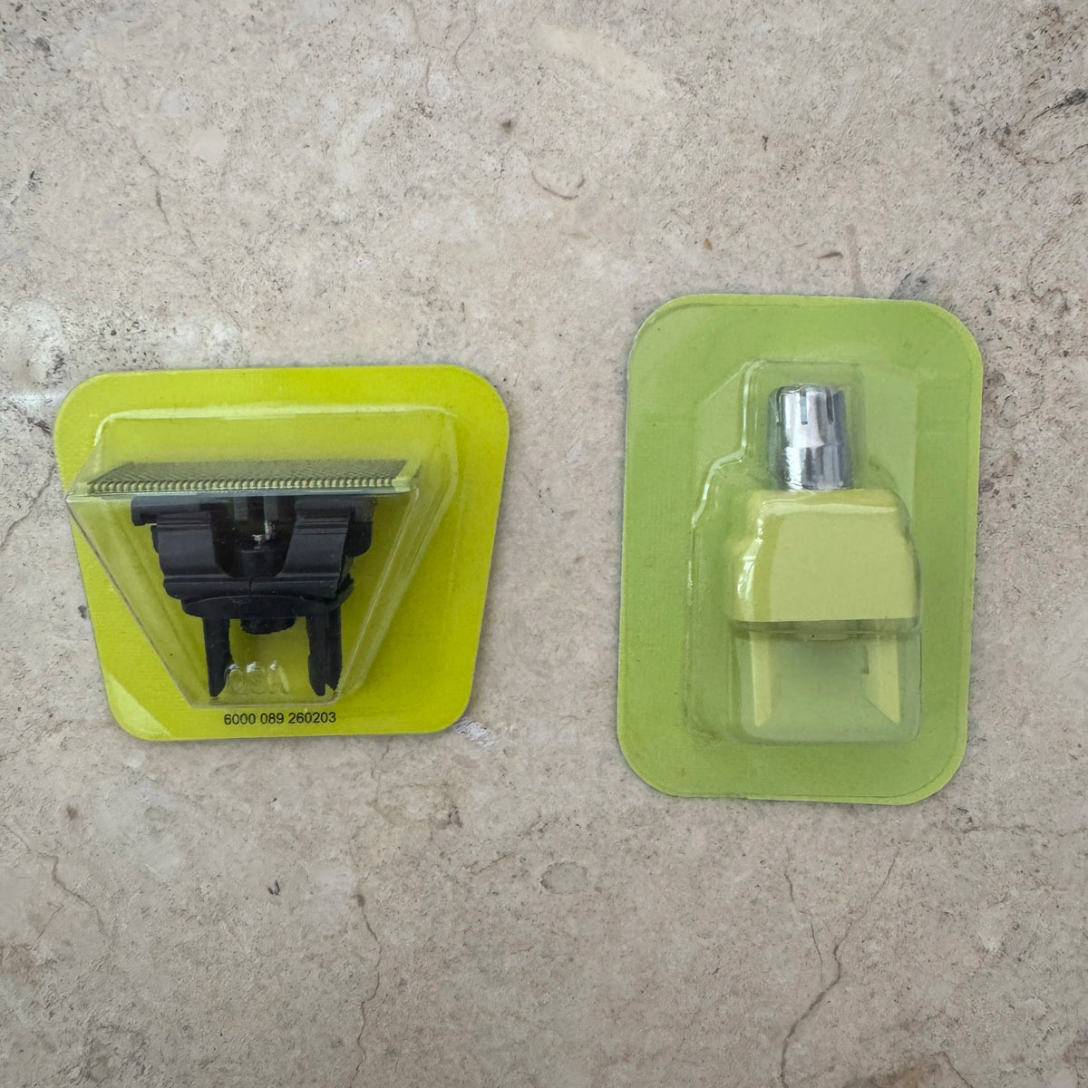A precision electric beard trimmer in yellow and green plastic packaging.