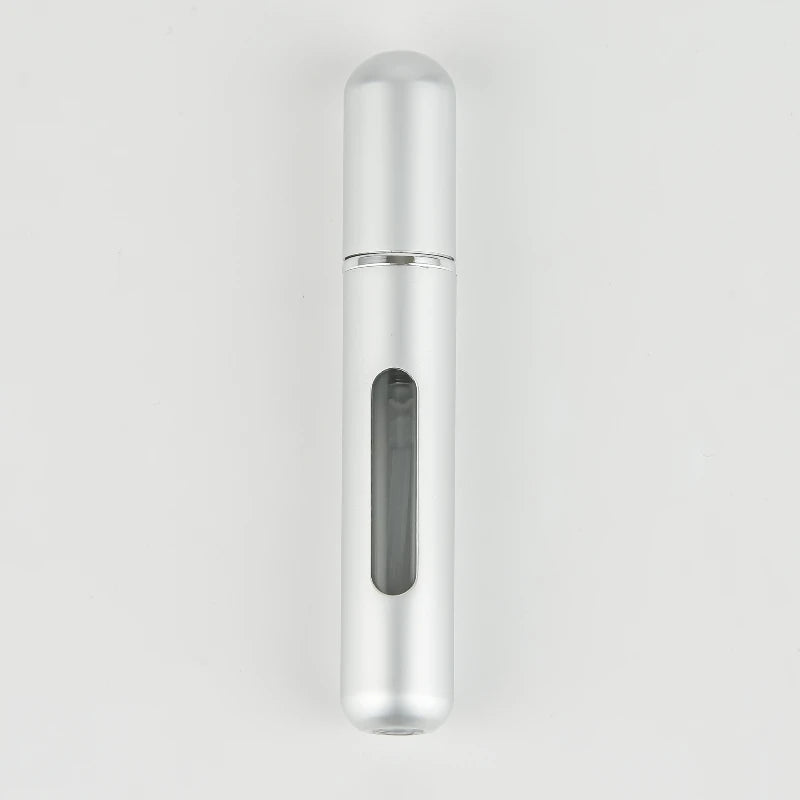 A sleek, cylindrical silver perfume bottle with a clear window for the liquid.