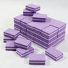 A stack of purple multi-sided nail and cuticle buffing files in various sizes.