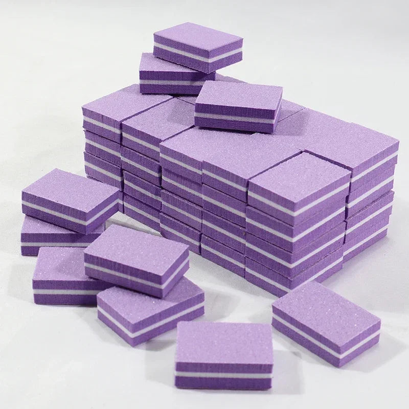 A stack of purple multi-sided nail and cuticle buffing files in various sizes.