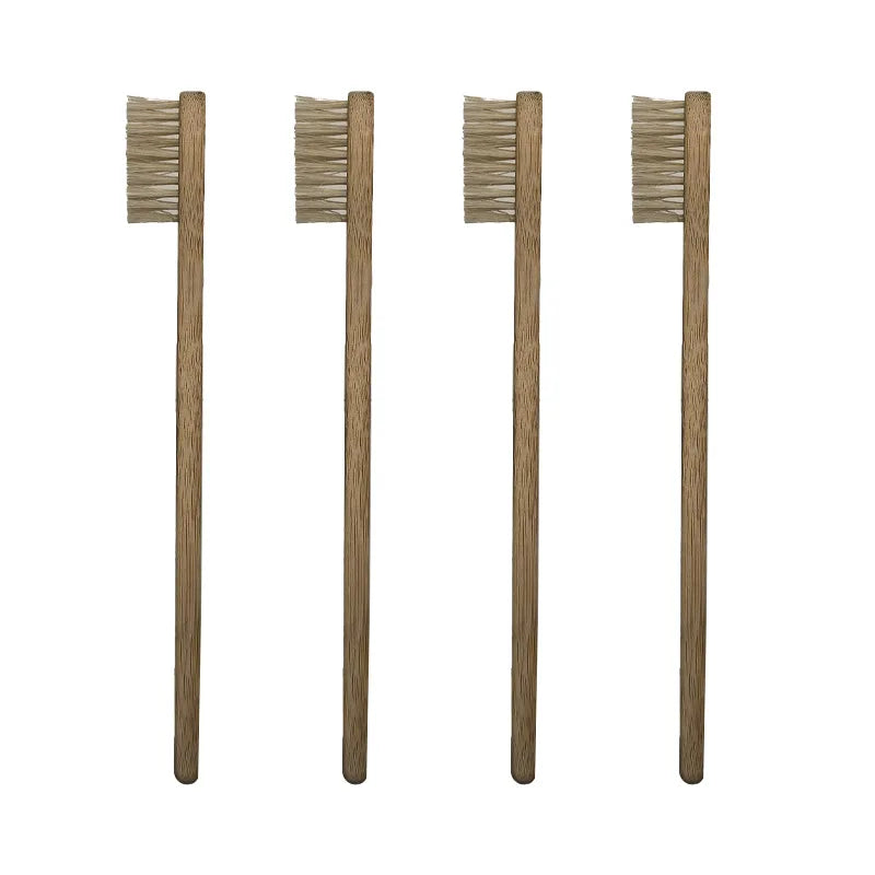 Four wooden bamboo toothbrushes with natural bristles standing upright.