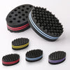 A set of black dual-sided hair braiding brushes with pink and blue accents.