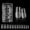 A collection of frosted French false nails in various natural finishes displayed in a clear plastic case and loose.