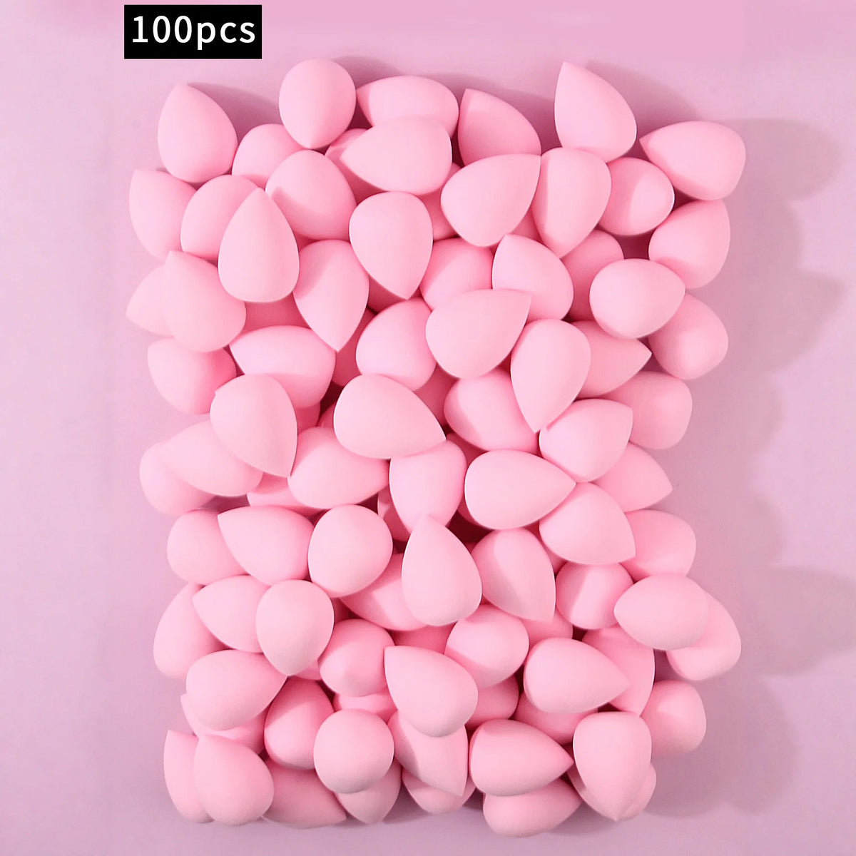 A pile of 100 pink XL soft makeup sponges for flawless application