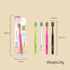 A package of pink and green soft bristle manual toothbrushes with measurements shown.