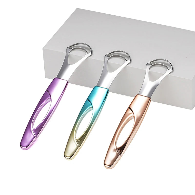 Tres raspadores de lengua de acero inoxidable en morado, verde azulado y oro rosa exhibidos en una caja blanca.