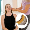 A woman is using a lymphatic contour face brush for facial sculpting on another person's face.