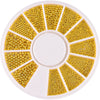 A circular plate filled with gold mixed stainless steel bead nail art decorations arranged in radiating sections.