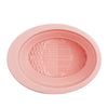 A pink silicone makeup brush cleaner and drying stand set with textured surfaces.