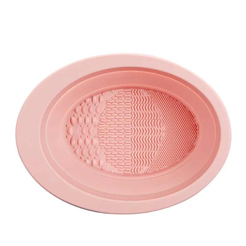 A pink silicone makeup brush cleaner and drying stand set with textured surfaces.