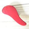 A bright red classic detangling hair brush shown in a profile view.