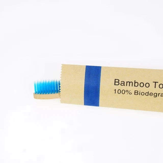 A package of bamboo toothbrushes with blue bristles and a label indicating 100% biodegradable.