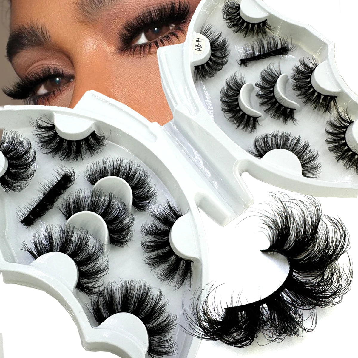 A close-up of a white eyelash extension kit with black false lashes and a model's eye.