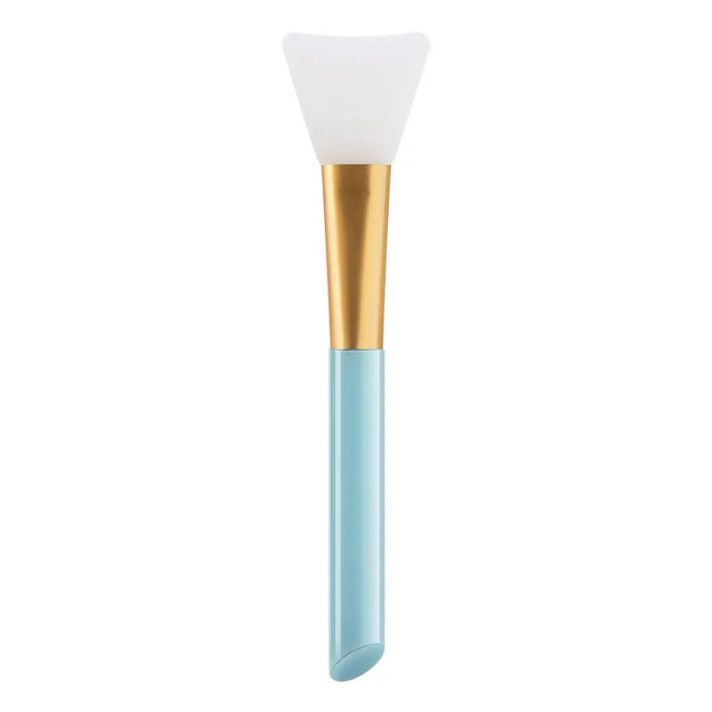 A silicone facial mask applicator brush with a white head and a gold handle.