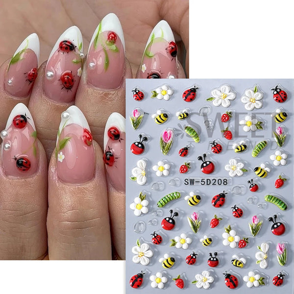 Embossed floral nail art stickers featuring spring designs on a pink nail bed.