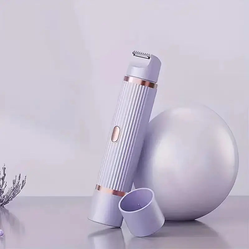 A silver portable dual-head electric shaver is shown next to a white spherical object on a light surface.