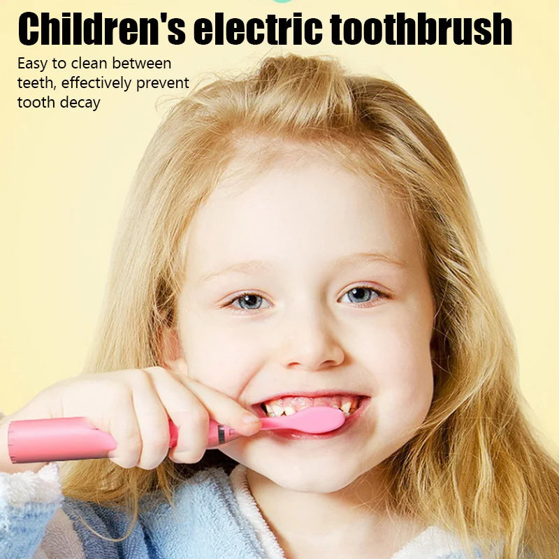 A smiling young girl holding a pink electric toothbrush and demonstrating its use.