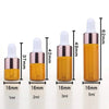 A set of five glass dropper bottles containing essential oils or samples in various volumes from 1ml to 5ml.