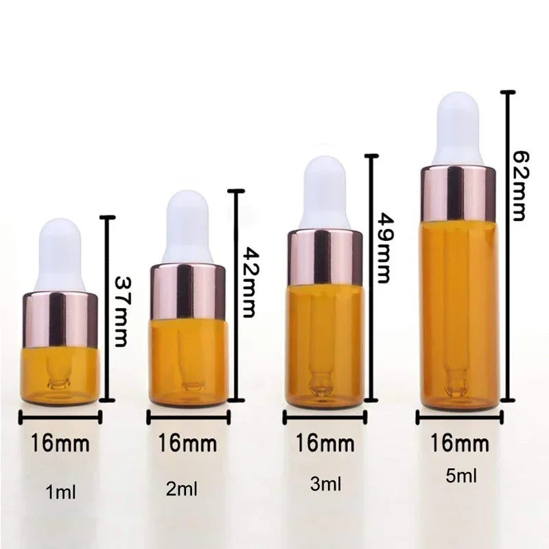 A set of five glass dropper bottles containing essential oils or samples in various volumes from 1ml to 5ml.