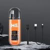 An orange electric hair clipper set with a clear casing and black charging cable resting on a dark rock.