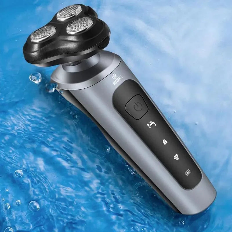A silver electric shaver and trimmer with a detachable head is shown submerged in blue water.
