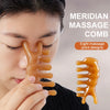 A close-up of a golden massage comb tool being used on a person's face for facial massage.