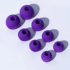 A collection of purple silicone earplugs arranged diagonally on a white background.