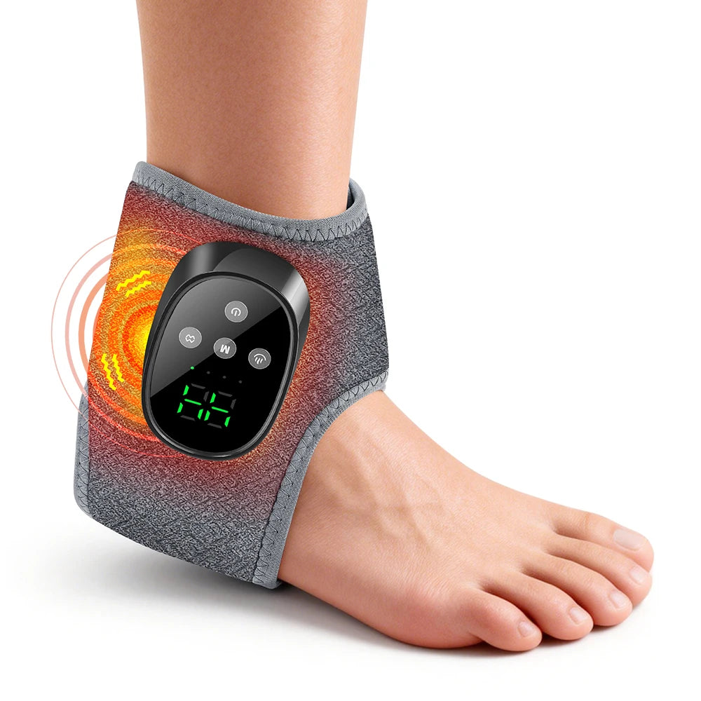 A black electric foot and ankle massager worn on the wrist, demonstrating its use on the foot.