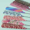 A set of anti-static rat tail combs featuring various floral and abstract patterns in pink, purple, and black.