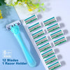 A blue razor holder with twelve green blades is displayed on a white surface next to some flowers.