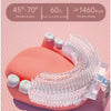A pink electric toothbrush with a U-shaped head and clear bristles is shown on a pink background.