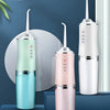 A white portable oral irrigator device shown in various colors on a stand.