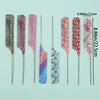 A set of eight anti-static rat tail combs in various pink and purple patterns displayed against a light green background.