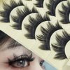 Close-up of a person's eye with Paris Cat Eye false eyelashes applied, showing the long and thick strip lashes.