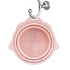 A pink silicone makeup brush cleaner and drying stand set with a metal hanger.