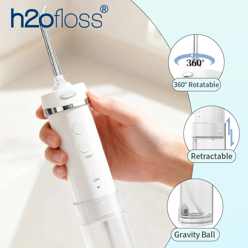 A hand holds a white portable water flosser device, highlighting its 360° rotatable head, retractable design, and gravity bal