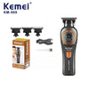 Kemei KM-999 electric hair clipper and accessories including combs and a charging cable