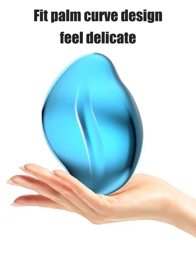 A hand holds a smooth, teardrop-shaped blue glass tool designed to fit the palm curve for delicate use.