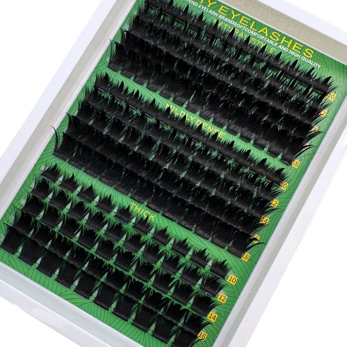 A tray of thick spiky cluster eyelash extensions in black and green packaging.