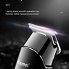 A close-up of a black Kemei precision steel cutter hair and beard trimmer with a double-side fillet design.