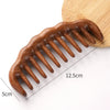 A close-up view of a wooden wide-tooth detangling comb with 12.5cm length and 5cm width.