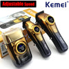 A set of black and gold Kemei adjustable speed cordless hair clippers shown with packaging.