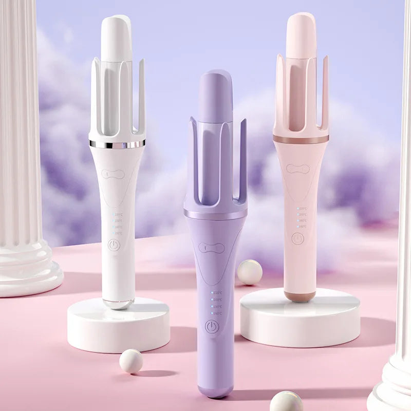 Three professional automatic hair curling irons in white and pink are displayed on a pink surface.