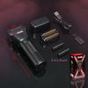 A black professional rotary shaver shown with an extra blade and accessories on a dark background.