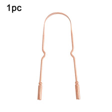A single natural copper tongue scraper with a handle and a rounded tip.