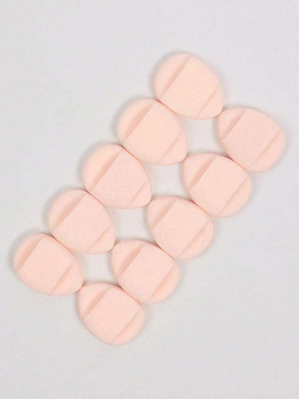 A cluster of pink latex-free finger puffs for makeup application