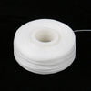 A spool of white dental floss for oral hygiene