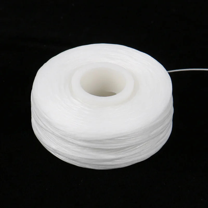 A spool of white dental floss for oral hygiene