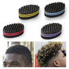 A black dual-sided hair braiding brush is shown in various forms and used on a person's hair.